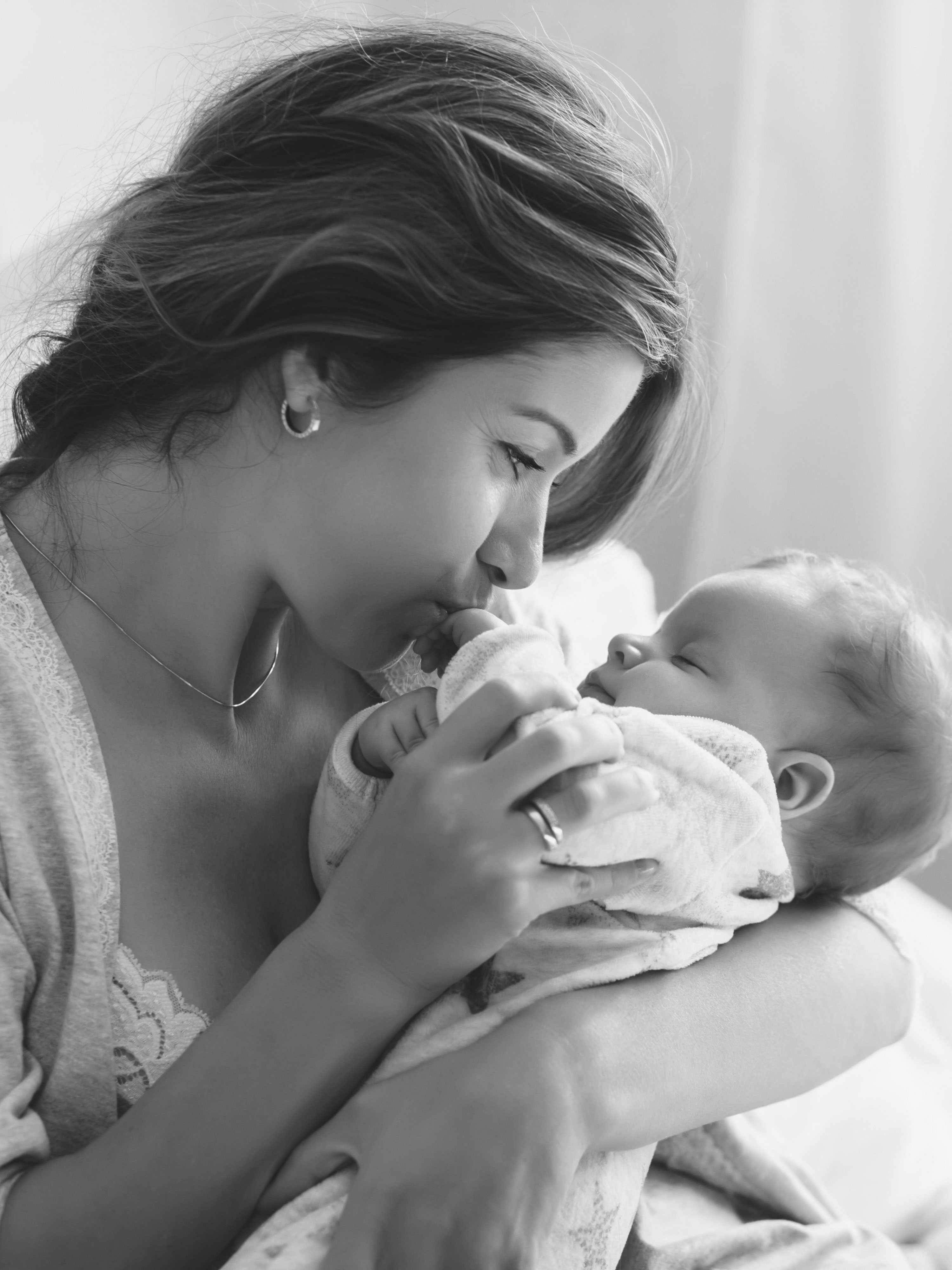 Mother holding a newborn baby, representing receiving